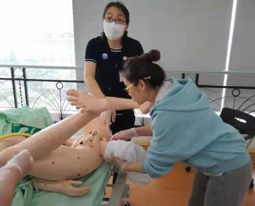 Chinese trainee learning the technique for breech delivery