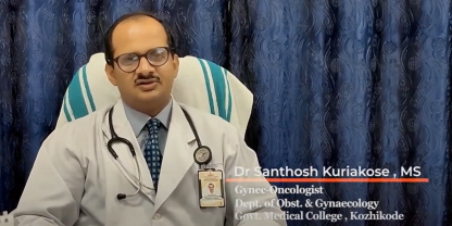 Image of Dr Santosh Kuriakose sitting down, wearing a white coat.