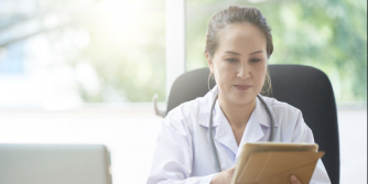 female doctor looking at tablet