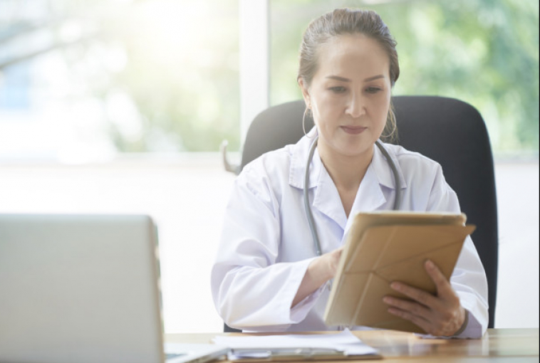 female doctor looking at tablet